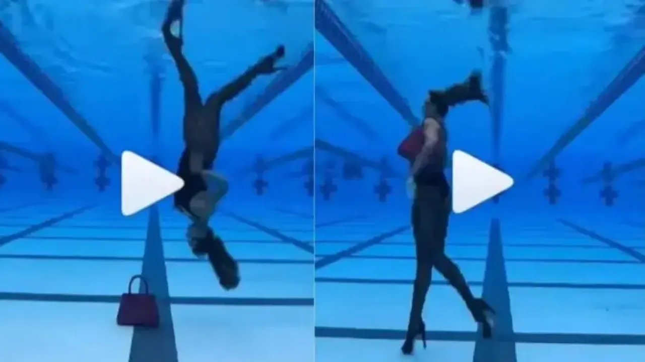 Girl does upside down catwalk inside swimming pool