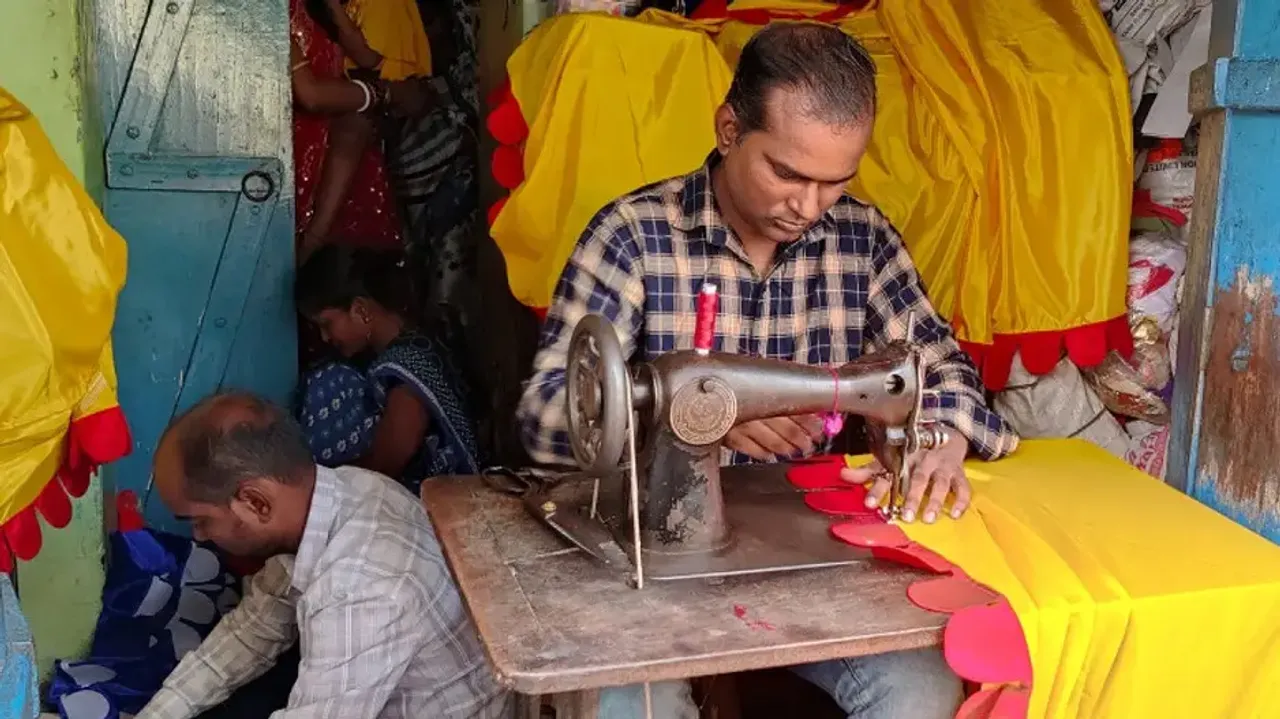 A tailor stitching a flag 