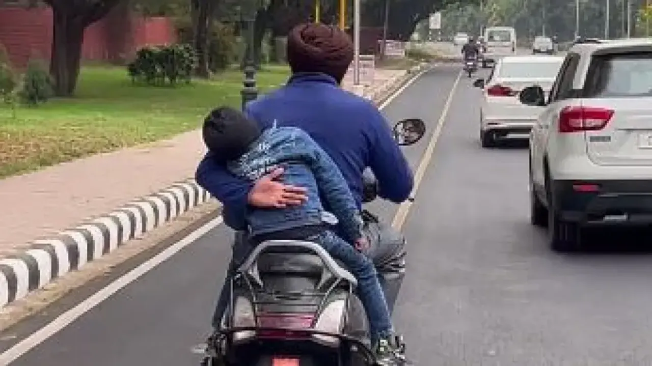 Fathers are real superheroes: Man holds dozing child in one hand while driving scooter #Watch