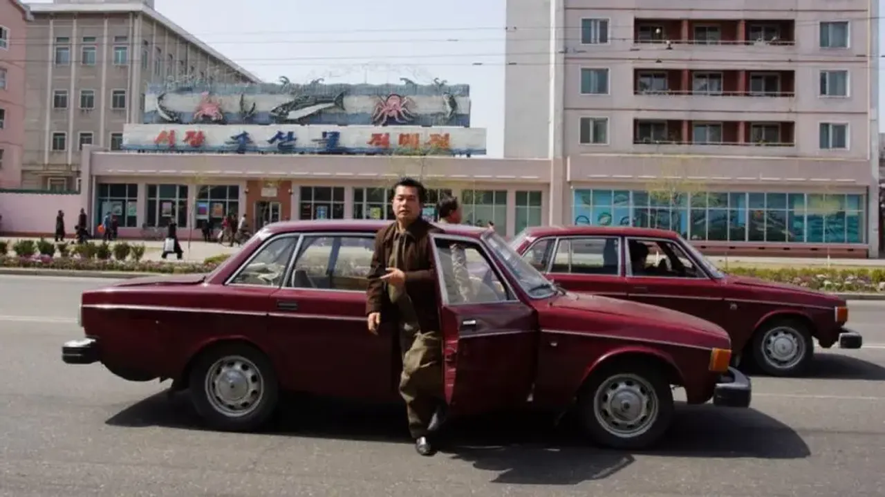 Man Alighting From A Volvo In North Korea