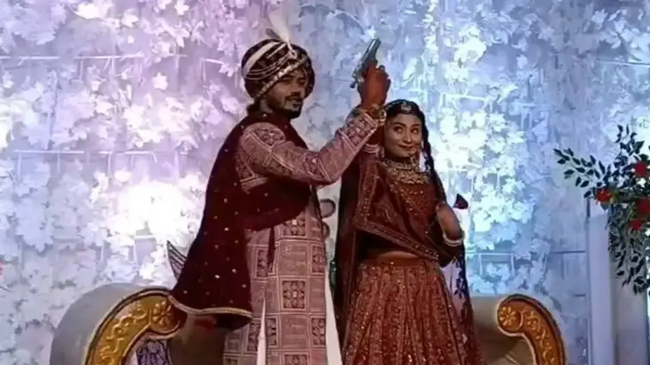 Couple fires shot on wedding stage