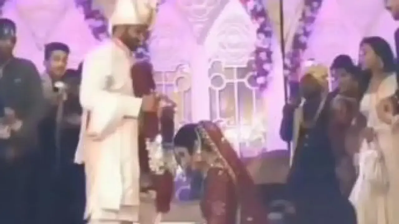 Bride goes down on her knees during ‘varmala’ ritual, viral video wins heart