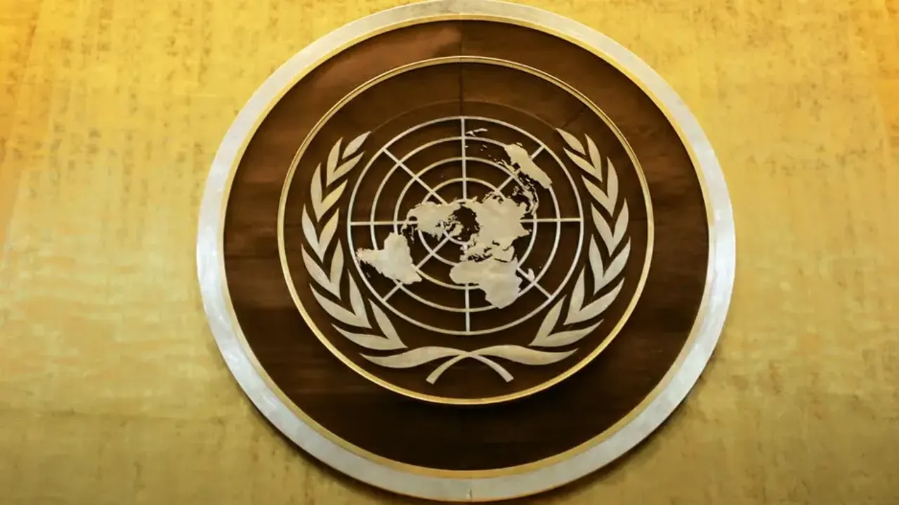 Plaque bearing the United Nations logo above the podium of the General Assembly Hall. 