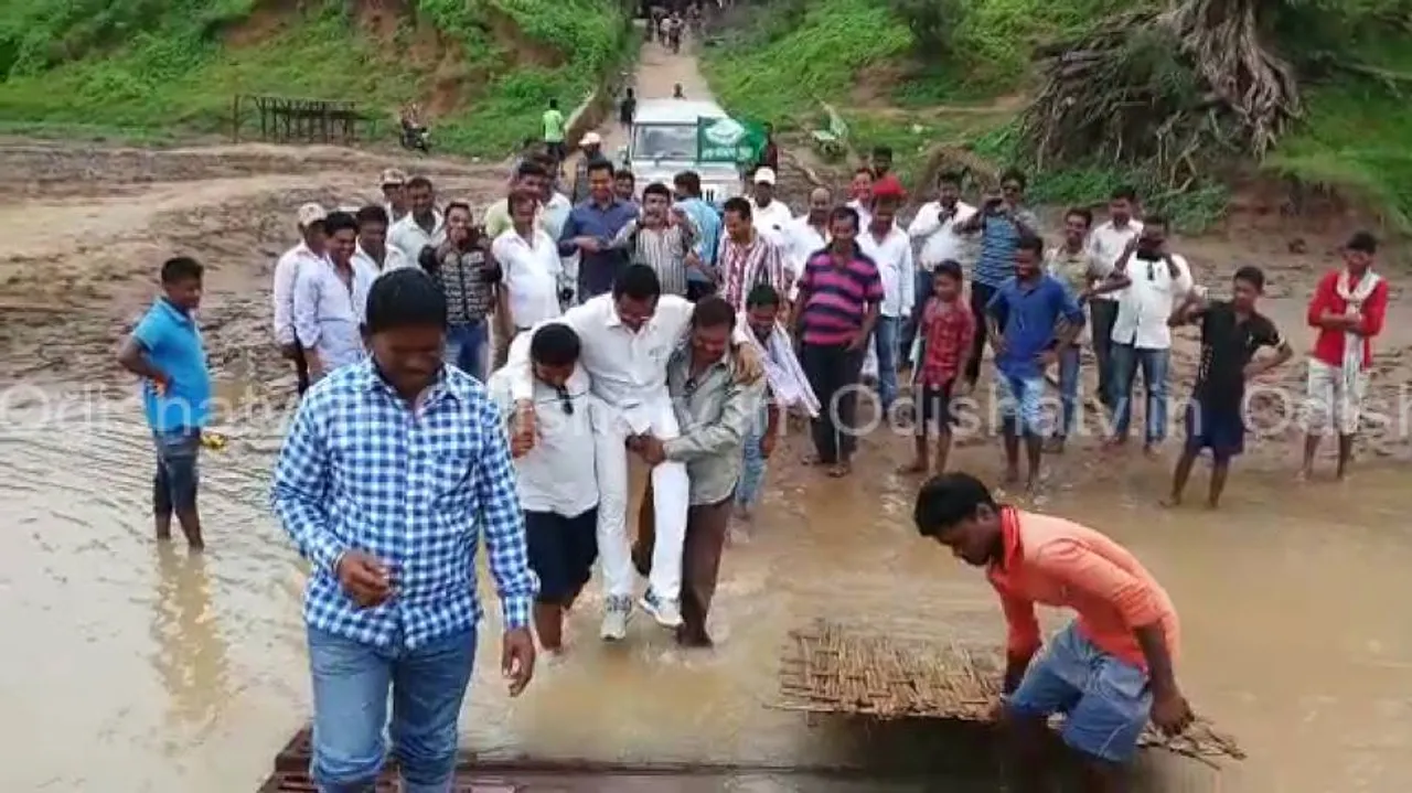 Supporters save MLA’s shoes, carry him through water