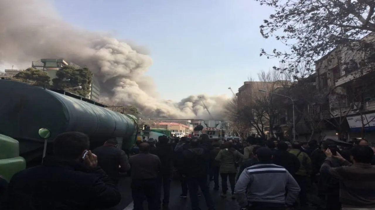 30 fire fighters killed as blaze topples Tehran's oldest trade tower