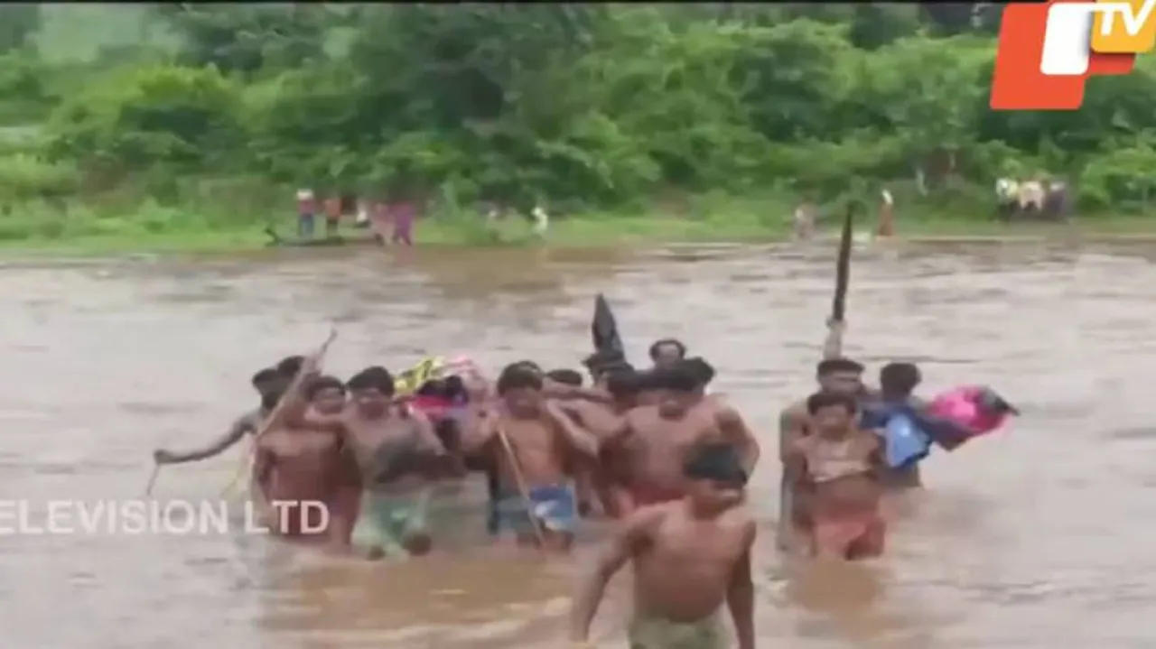 Troubled Waters! Families Cross River, Tread On Road Carrying Patients On Cots