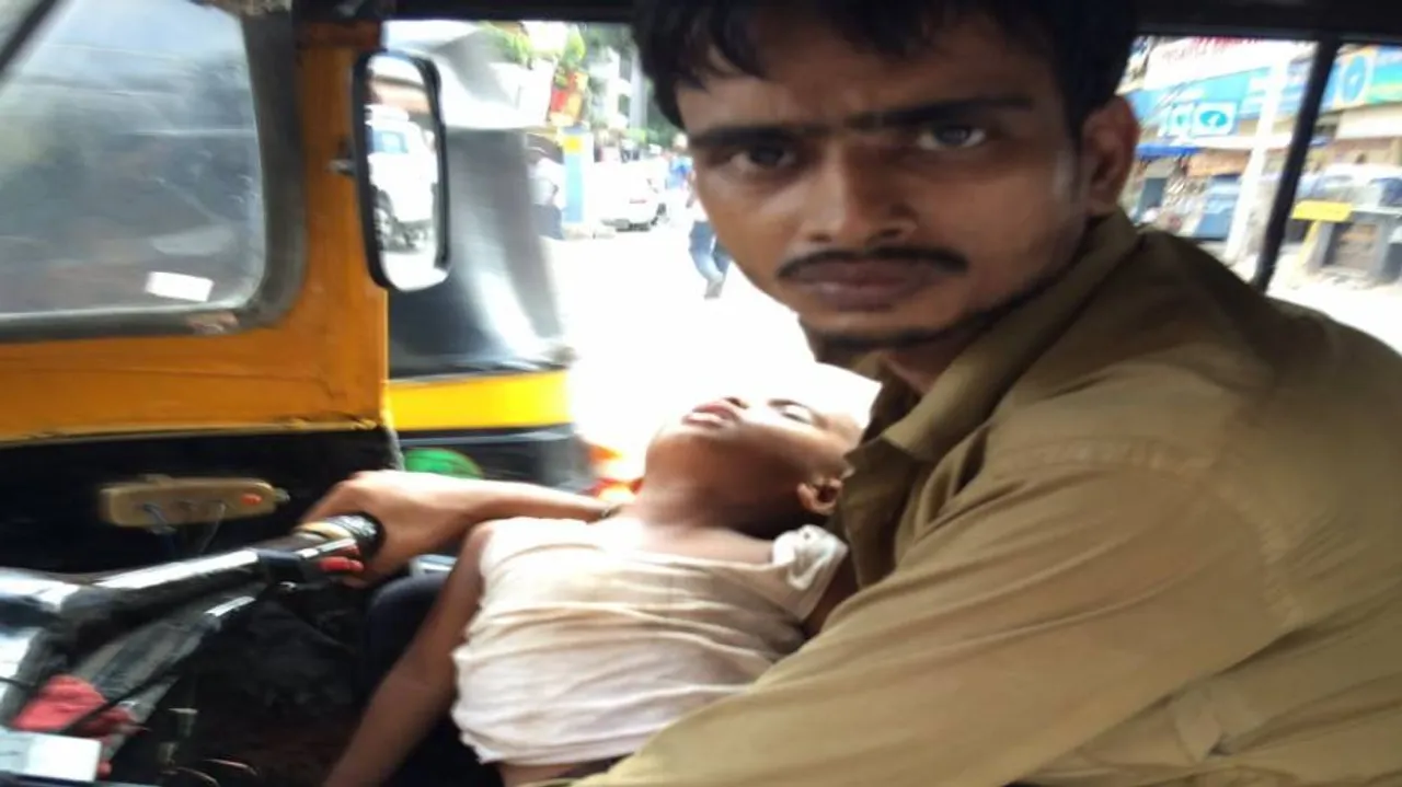 Son on lap, this auto driver earns a livelihood!