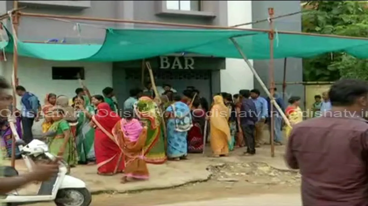 Women torch liquor shop, ransack local bars