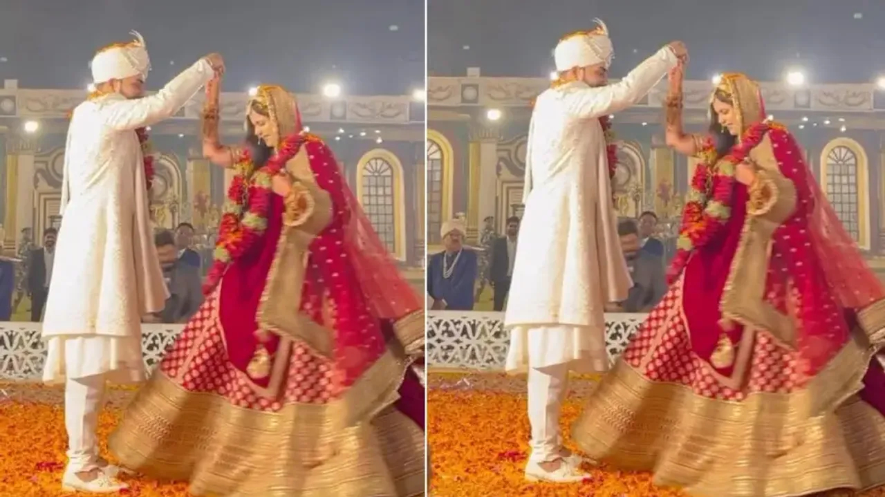 Groom’s loving gesture for bride on wedding stage