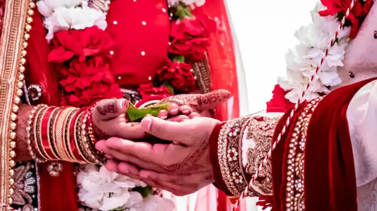 Groom pushes bride from wedding stage during jaimala ceremony