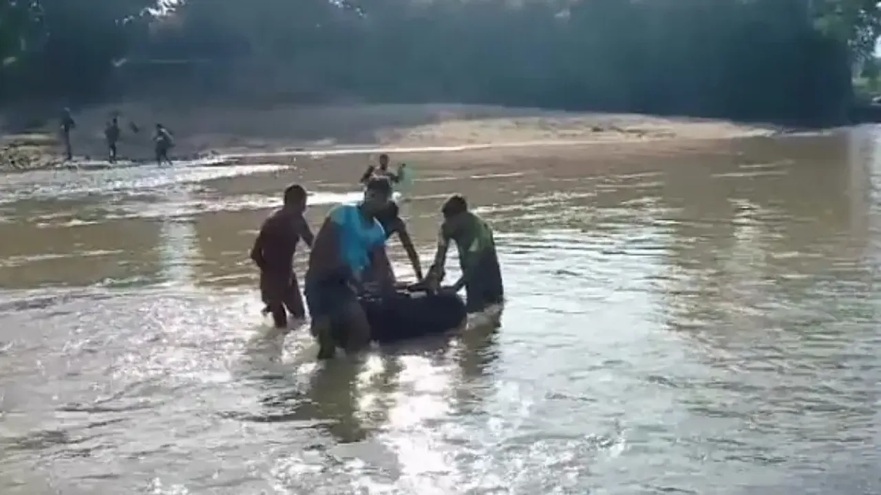 Patient crosses river in inflated tube