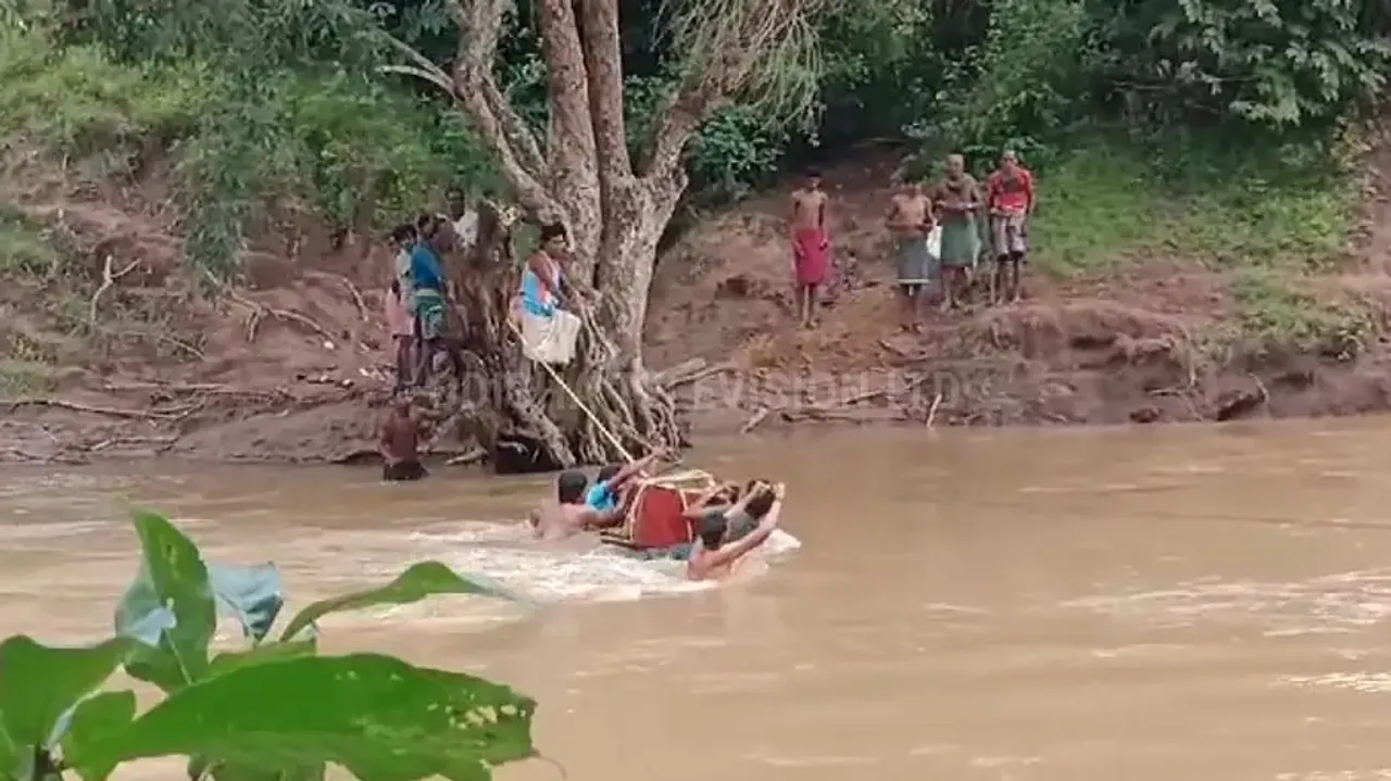 Locals carry dead body using cable to cross river