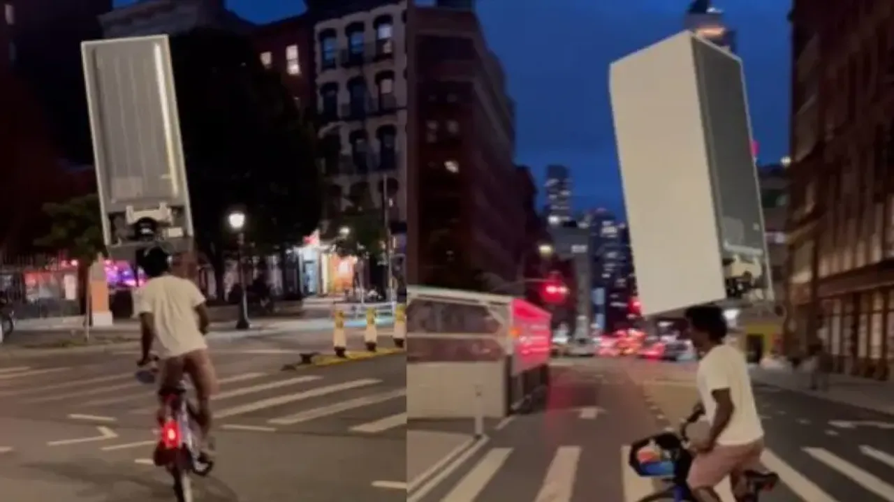  New York man carries fridge on his head while he rides bicycle