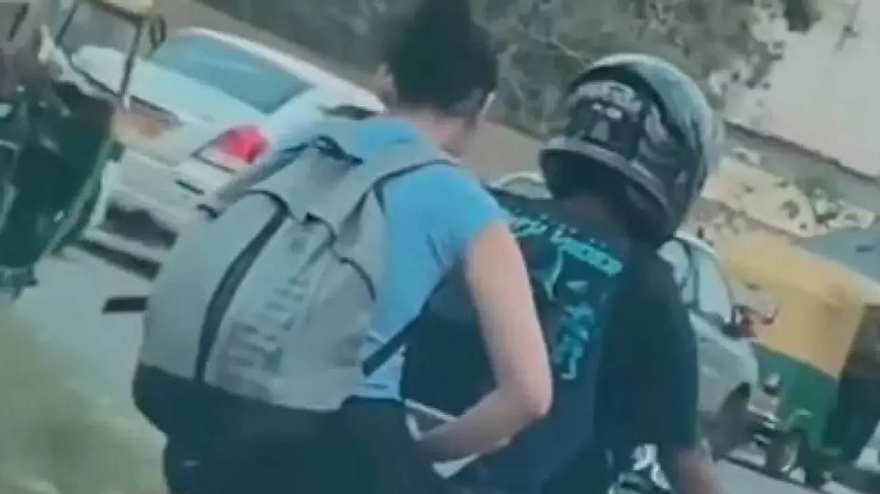 Peak Bangalore Moment: Woman spotted working on laptop while riding pillion on bike