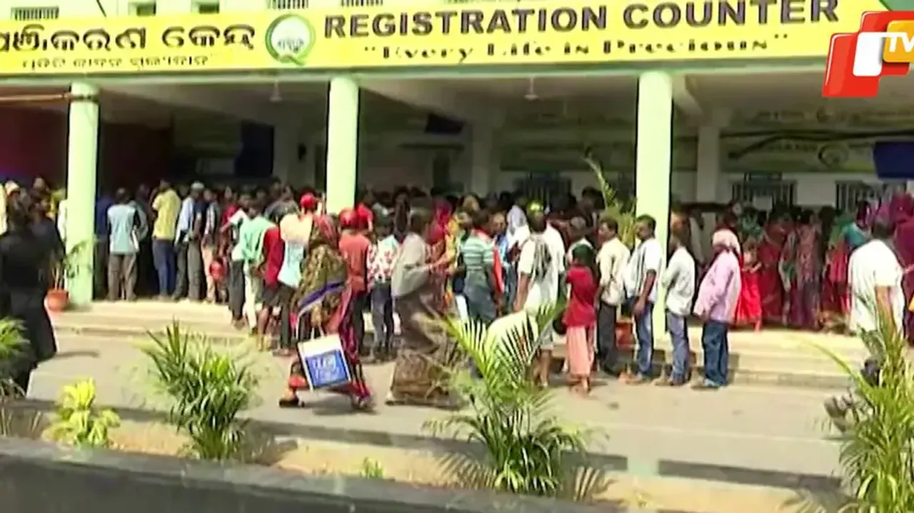 Patients and their attendants wait in long queues outside Balasore District Headquarters Hospital