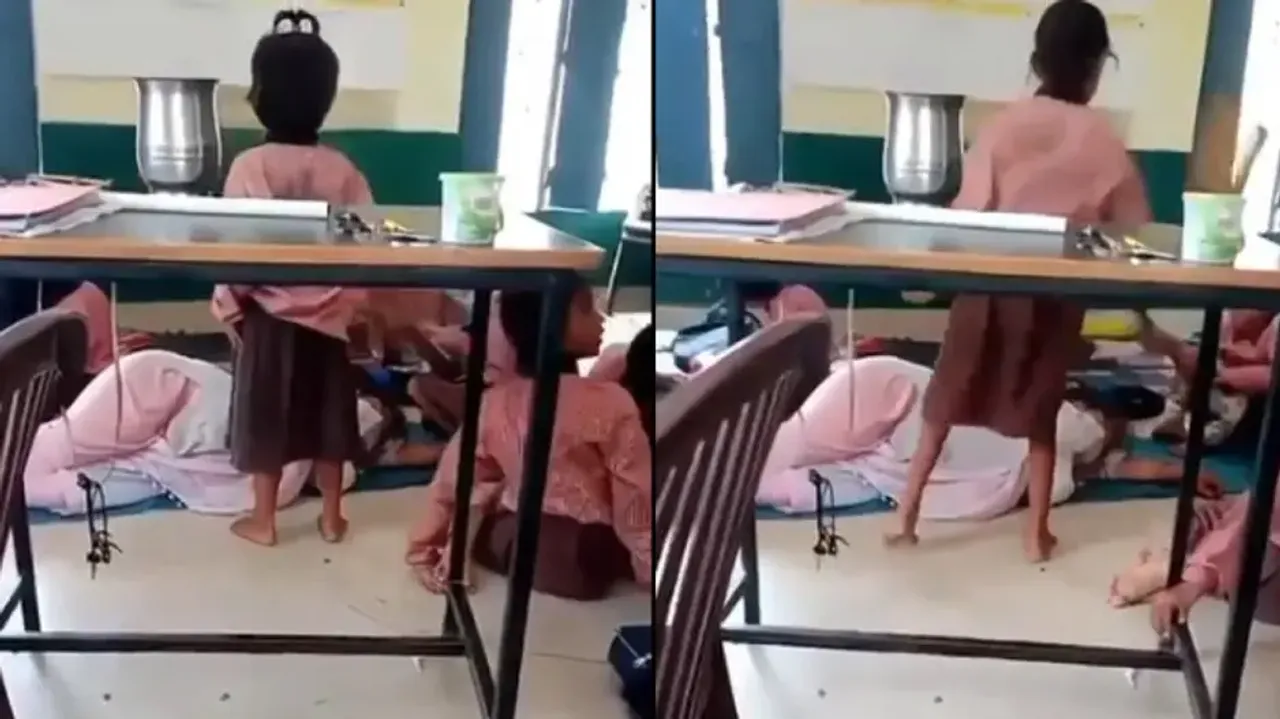 UP teacher sleeps in classroom while students fan her