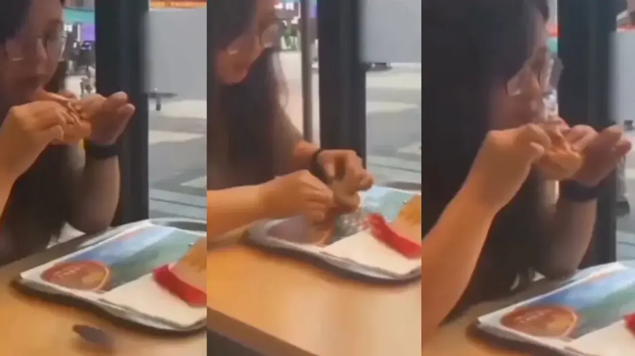 Creepy! Girl picks insect, stuffs it inside burger and takes a bite, watch
