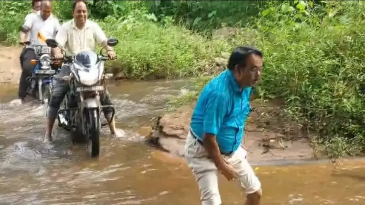 Doctors on bikes wade through stream to provide treatment to diarrhoea patients in Kandhamal