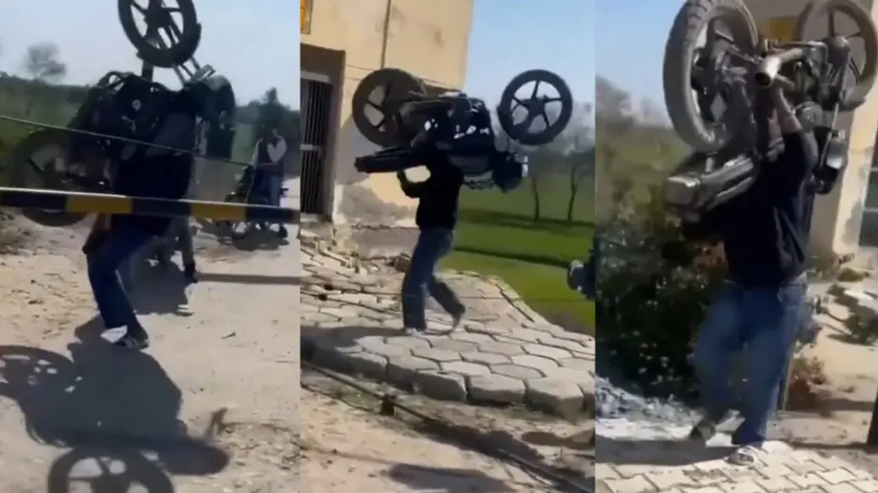 Man Lifts Bike On His Shoulder To Cross Railway Track