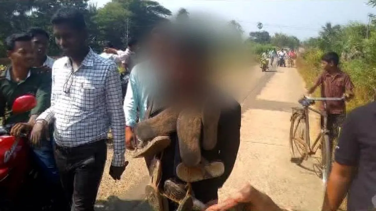 Youth garlanded with shoes, forced to walk on road