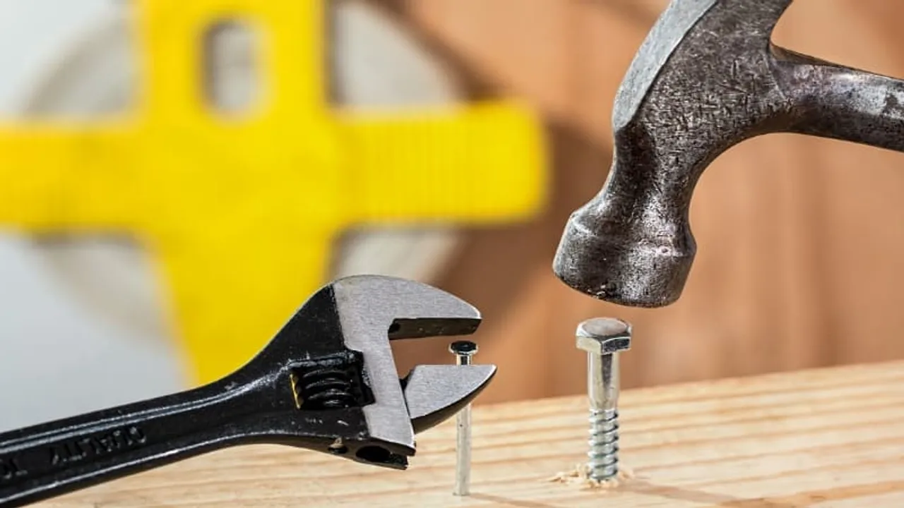 Hammering a nut on a wooden board