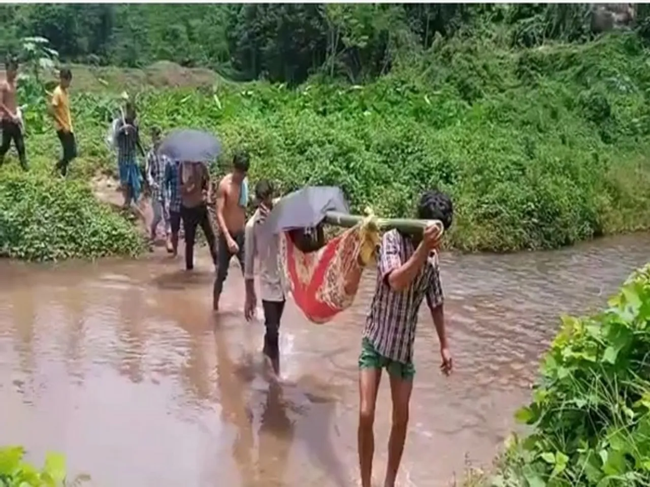 No Road, Bridge; Karbi Anglong Villagers Forced To Carry Patient On Shoulder To Reach Hospital