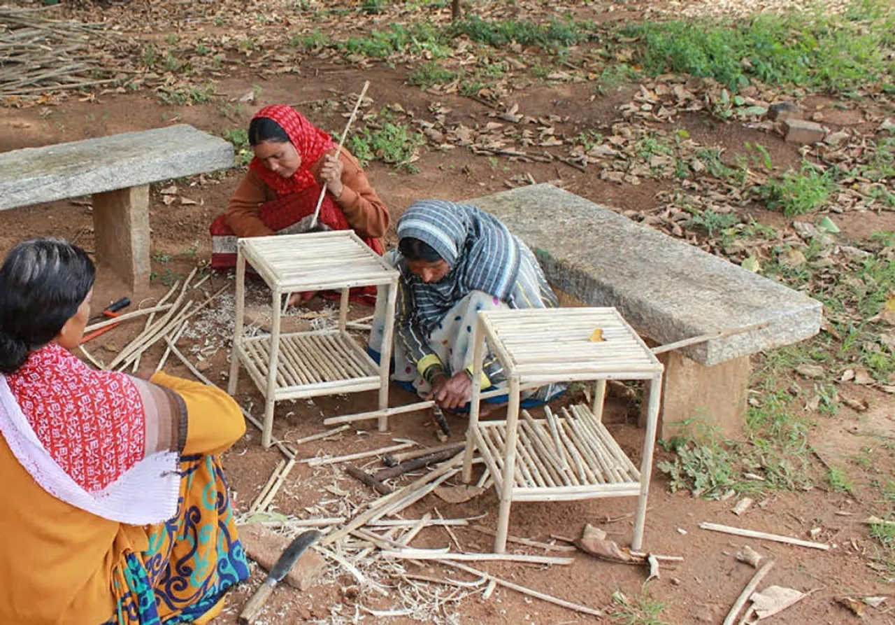 Women making products from lantana weed