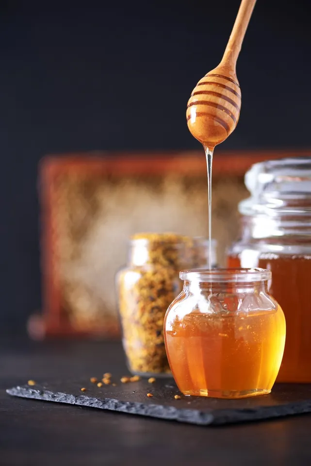 bee-pollen-granules-honey-jar-with-wooden-dropper-2024-10-18-04-26-26-utc (1)