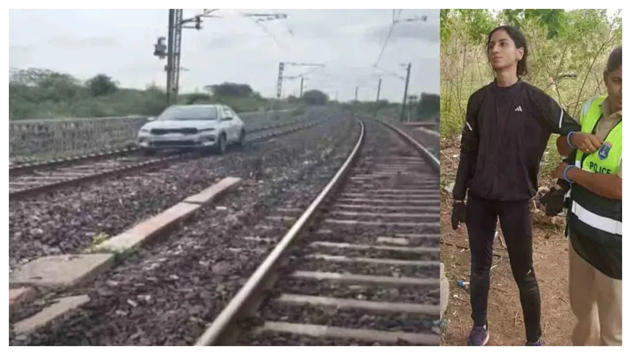 A young woman drove a car on a railway track.