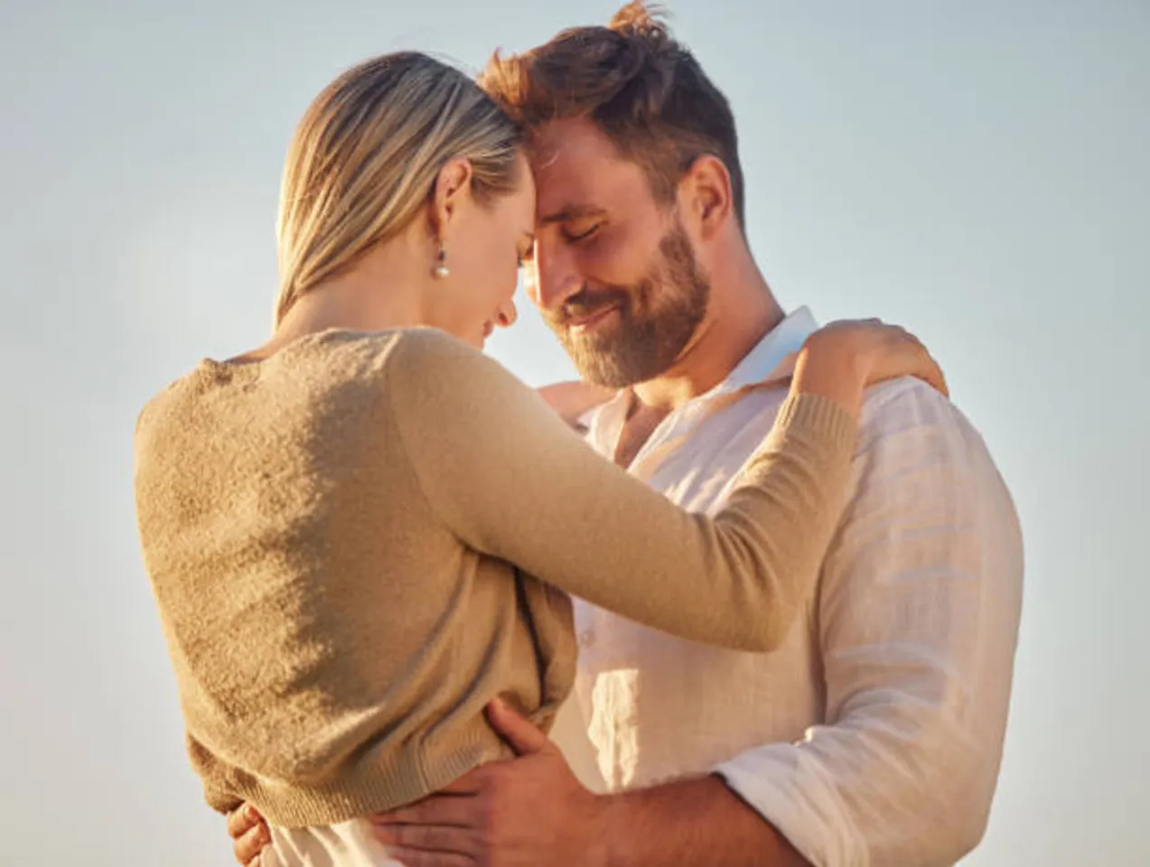 A couple holding each other, standing together 