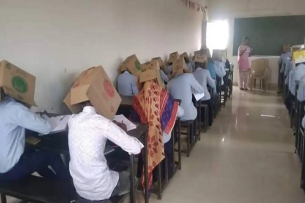 Karnataka college makes students wear cartons during exam to prevent cheating - தேர்வில் காப்பி அடிப்பதைத் தடுக்க உலக லெவல் அட்டெம்ப்ட்! டென்ஷனான அமைச்சர் (வீடியோ)