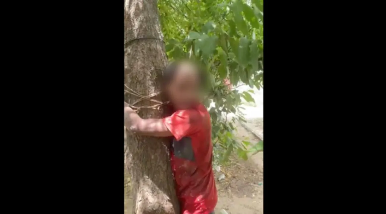 UP Village, man tied to tree, Jai Shree Ram, bulandshahr, ஜெய்ஸ்ரீராம் சொல்ல வற்புறுத்தல், மரத்தில் கட்டி வைத்து அடித்து, தலையை மழித்து இளைஞர் சித்ரவதை, 2 பேர் கைது, Uttar Pradesh, Bulandshahr, Man tied to tree beaten up head tonsured, Jai Shree Ram, bulandshahr village man beaten, india news, indian express