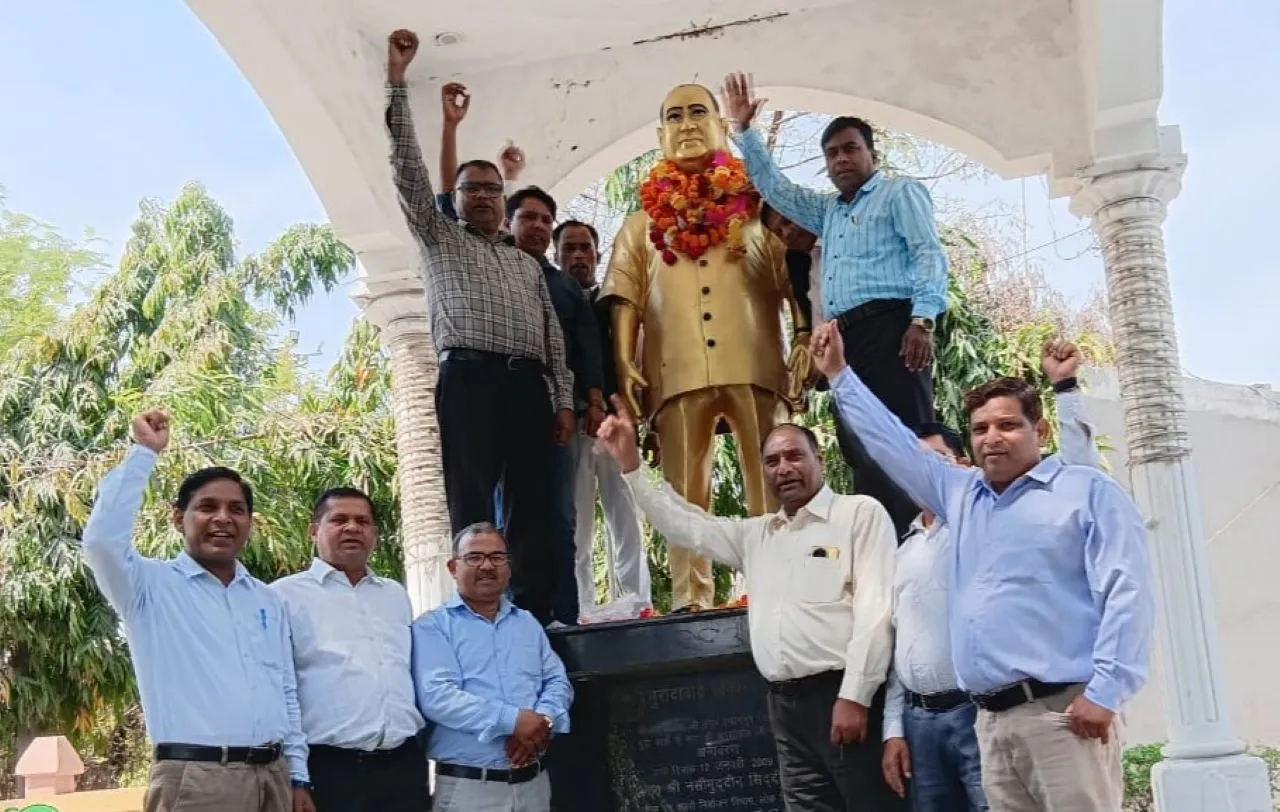 डॉ आंबेडकर की प्रतिमा पर माल्यार्पण करते लोग।