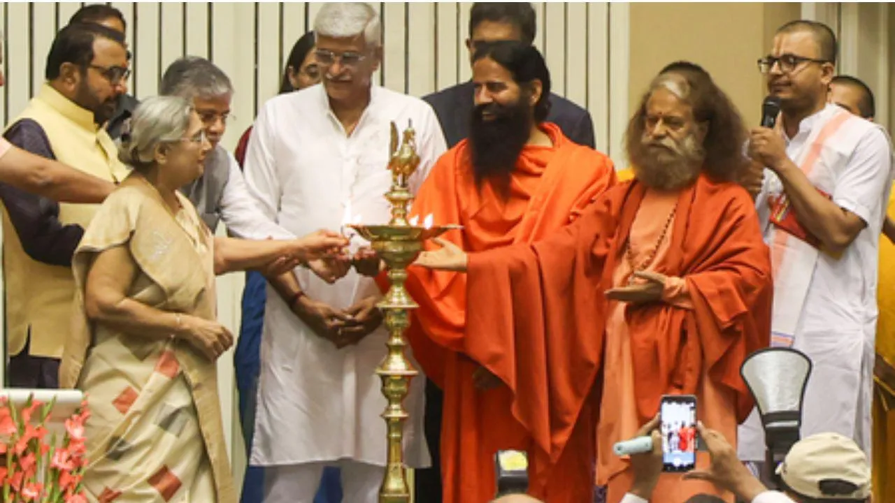 Union Minister Gajendra Singh Shekhawat, yoga guru Ramdev, Pujya Swami Chidanand Saraswati, Union Minister Prataprao Jadhav, and others light a lamp during the inaugural session of ‘Yoga Connect’ at Vigyan Bhawan 