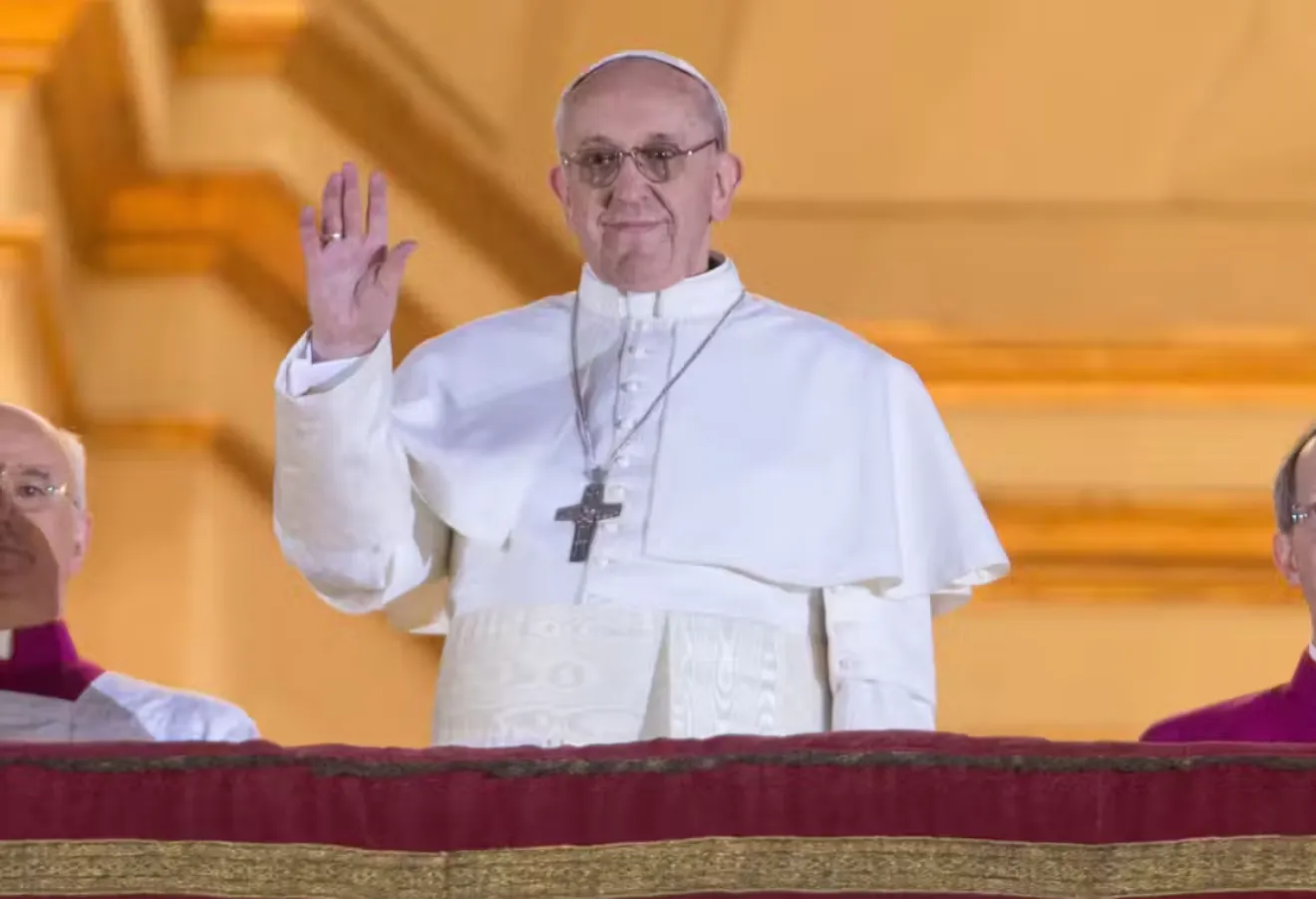Pope Francis on his first appearance after being elected in his untraditional white cassock. Michael Kappeler/ EPA