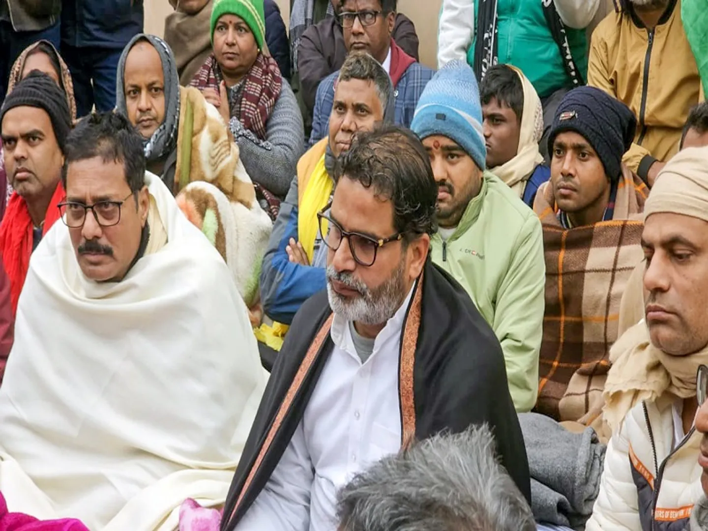 Patna: Jan Suraaj chief Prashant Kishor with others during an indefinite hunger strike demanding the cancellation of the 70th Integrated Combined Competitive (Preliminary) Examination (CCE), 2024, conducted by the BPSC, over allegations of a question paper leak near the Mahatma Gandhi statue in Patna on Saturday, January 04, 2025. (Photo: IANS)