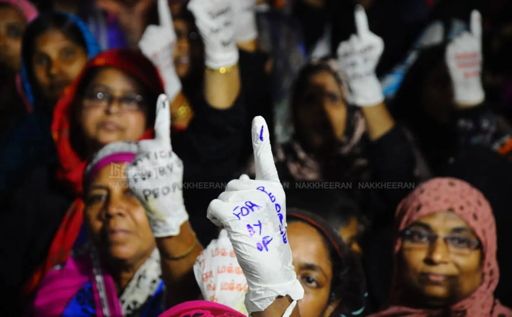  People raising their hands against CAA 