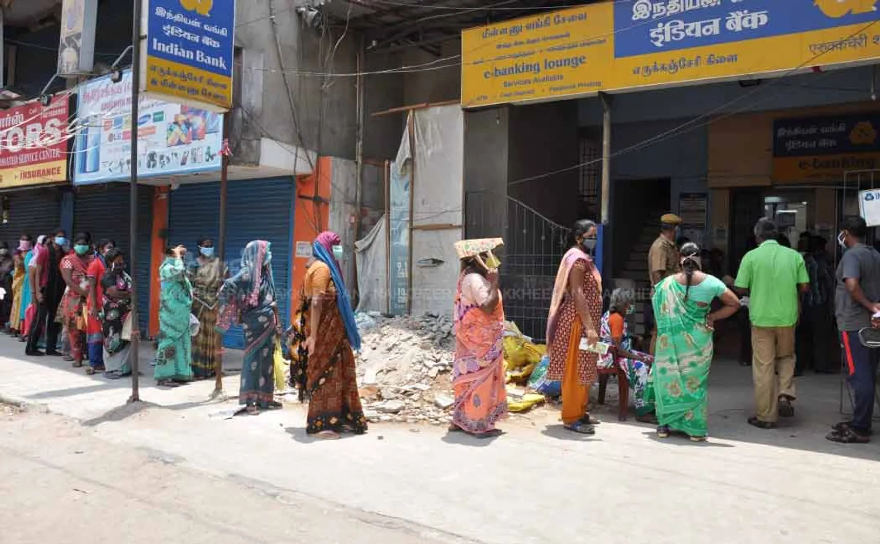 People waiting in long queues in Indian bank
