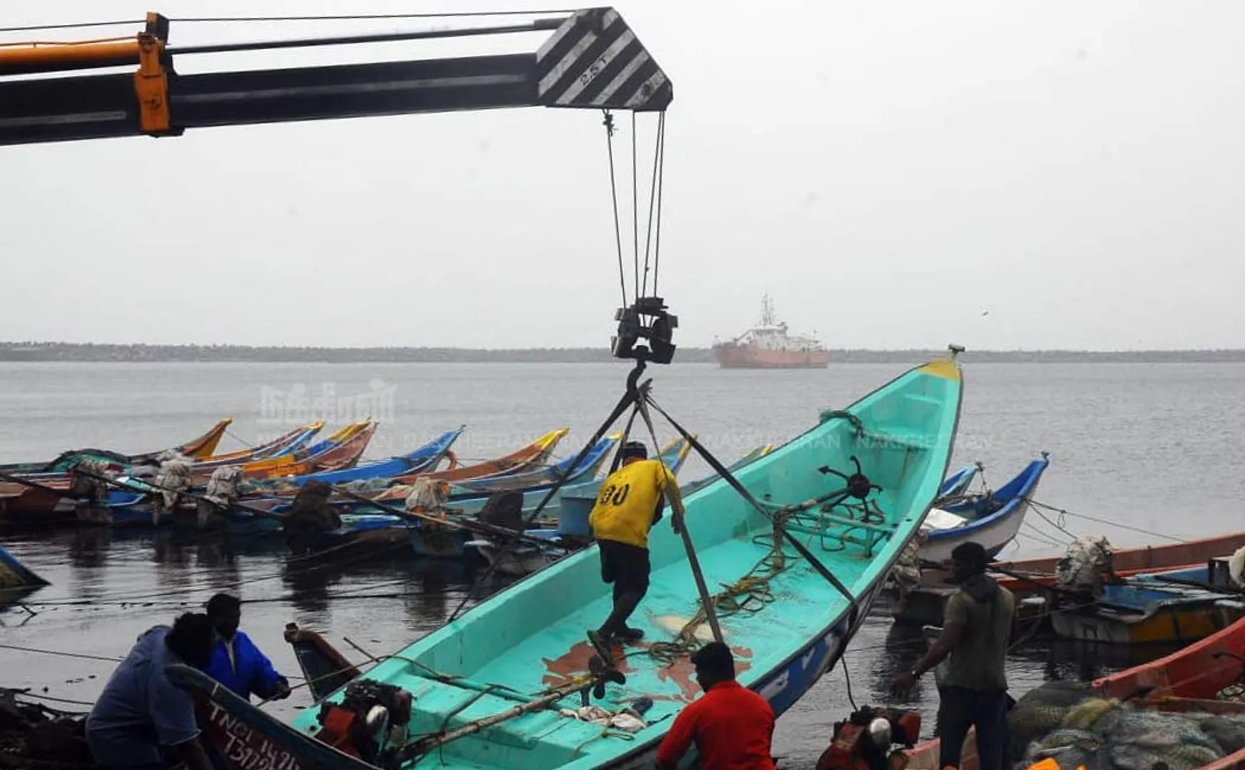 Fishermen in an effort to protect boats from Nivar Cyclone