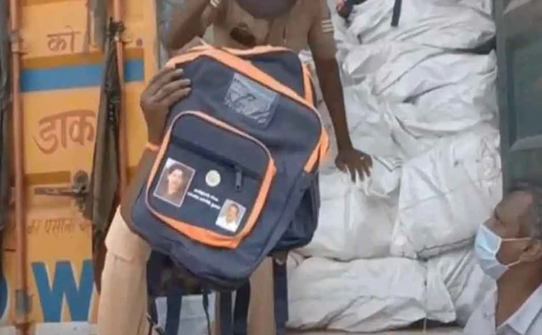 Is there money in the bags with the picture of the Chief Minister? Container  
