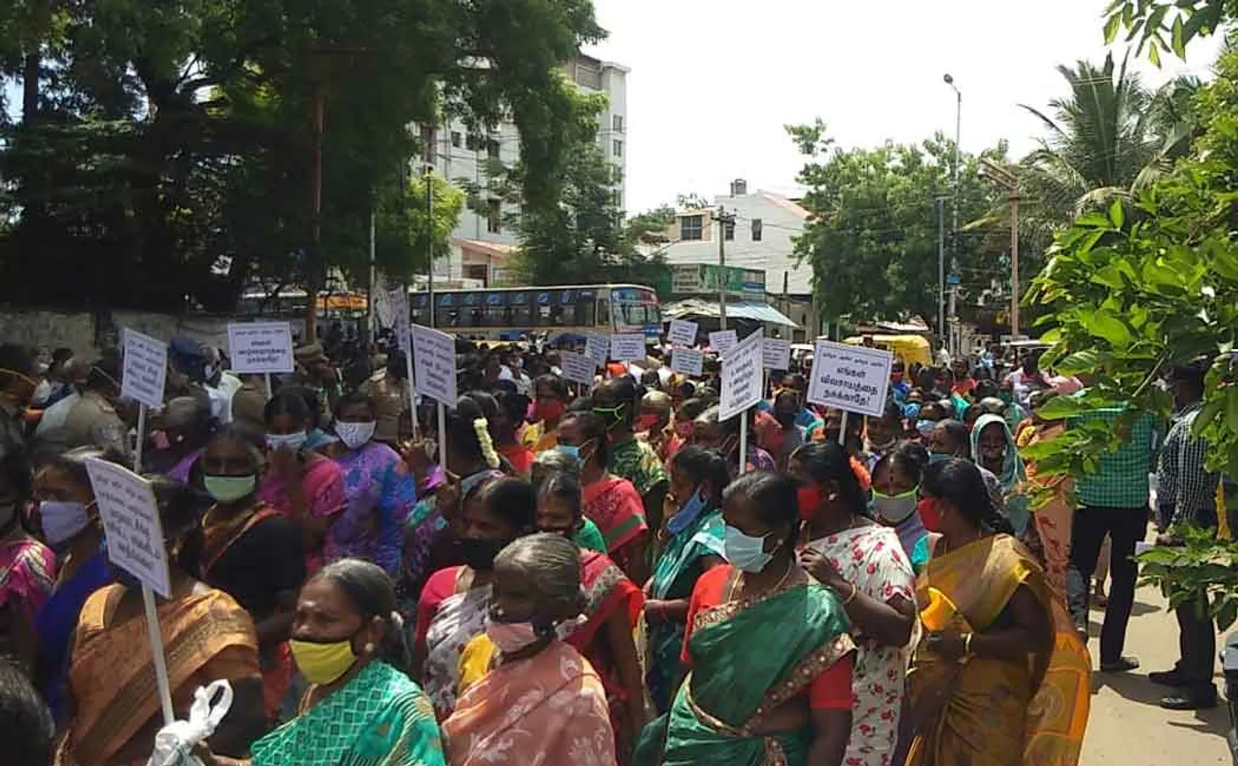 Women carrying banners and involved in struggle