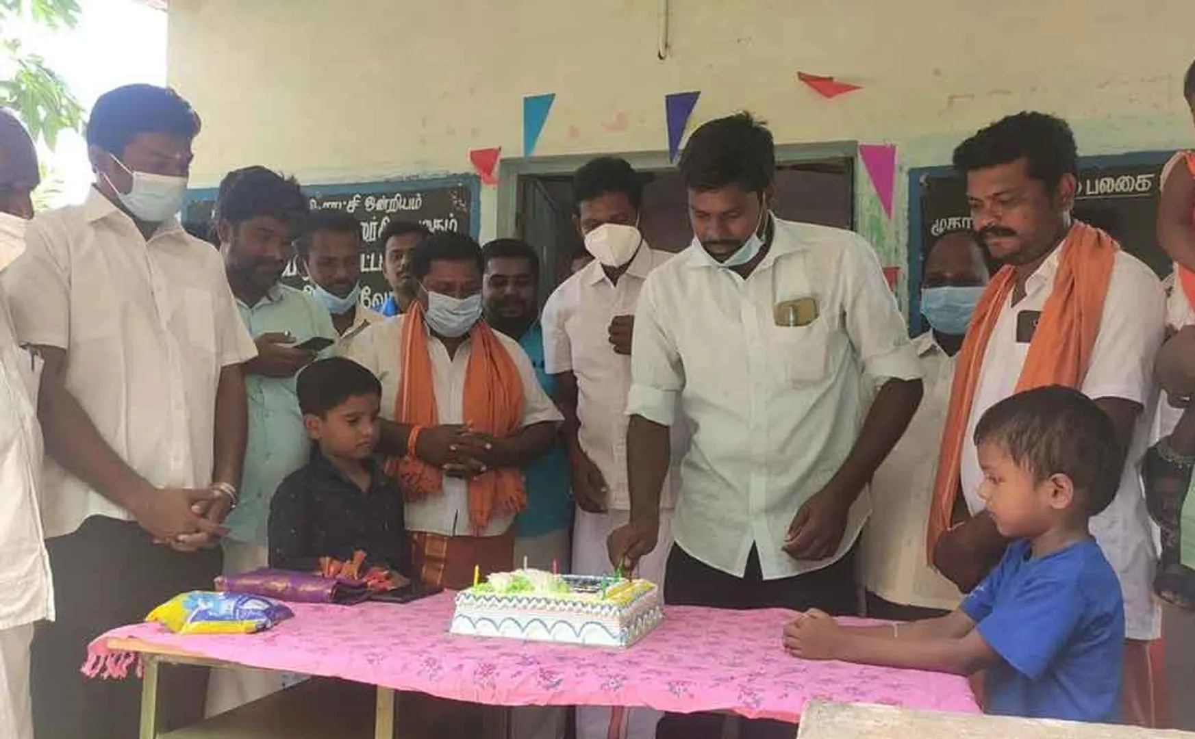 Villagers celebrating the birthday of an honest village administration officer  