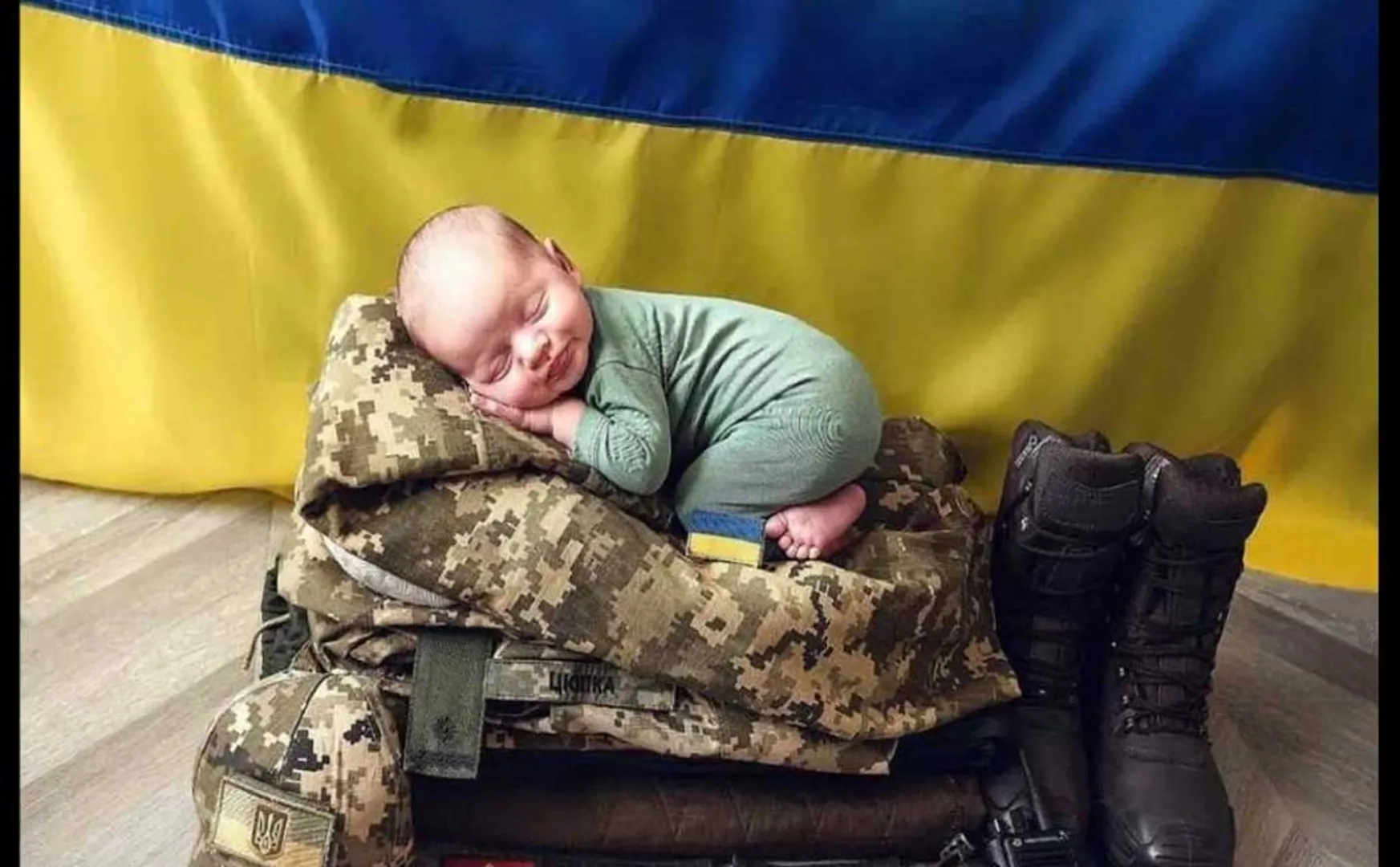 Baby sleeping peacefully on father's military uniform!