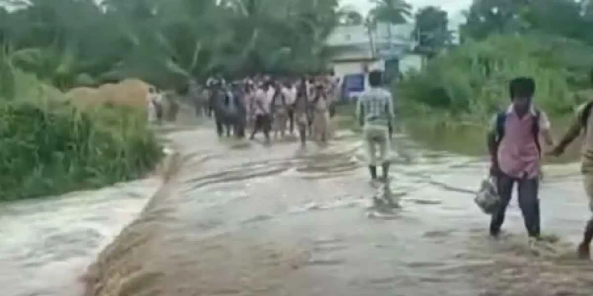 Students crossing the flood dangerously!