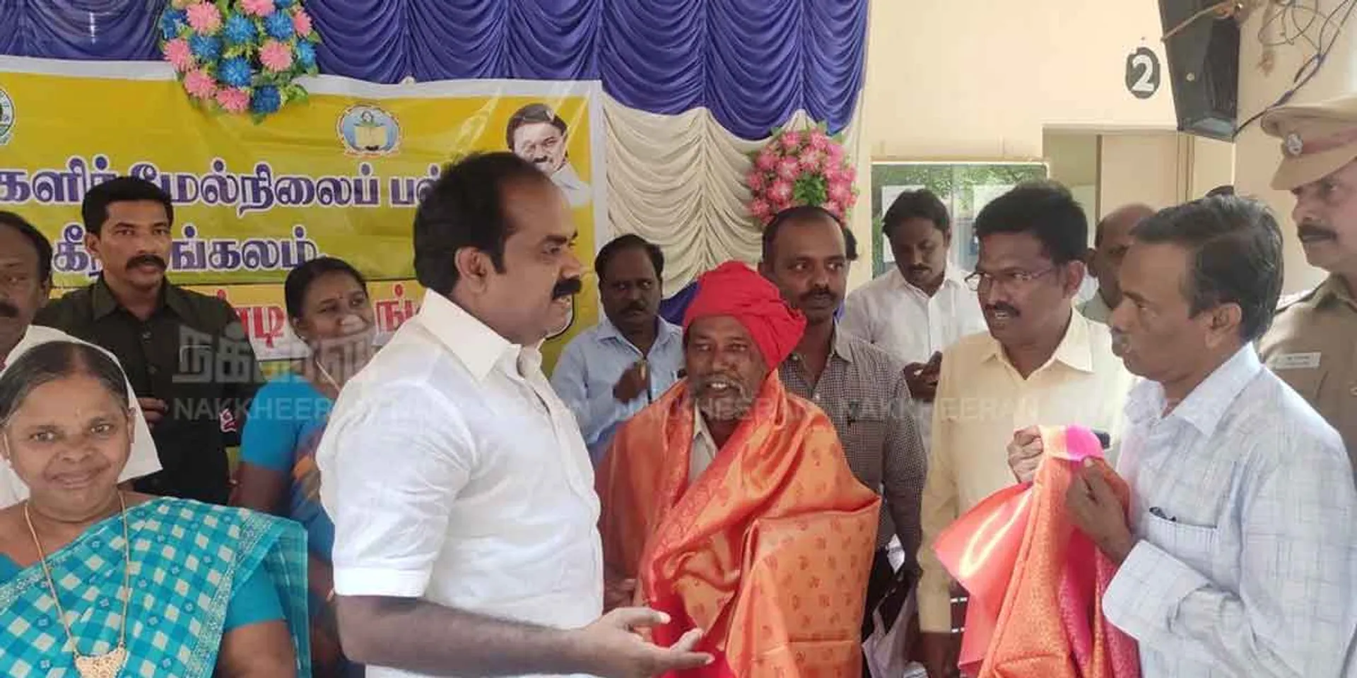 The minister put a shawl on the  who came to give the petition and heard the request