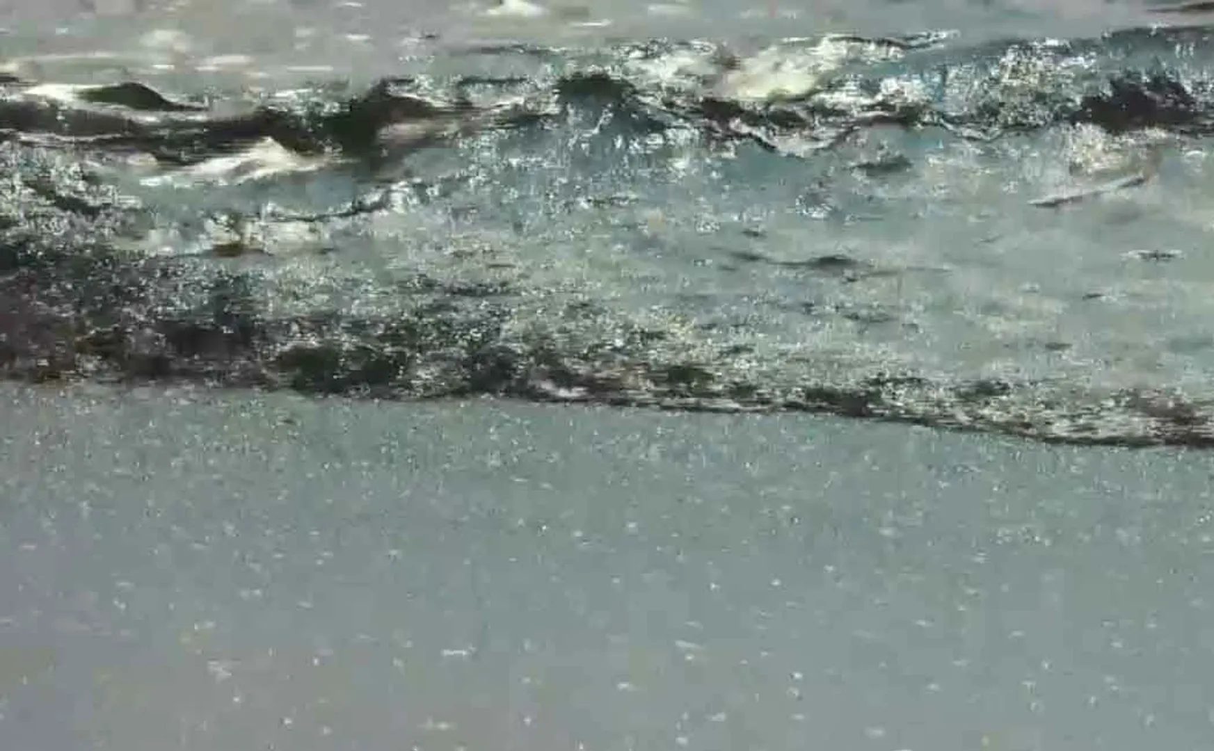 Oil floating in the ocean after a pipeline breaks; 