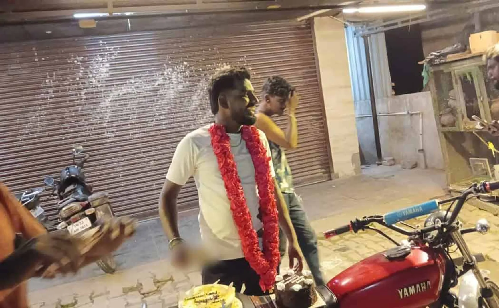 Young people cut the cake in the middle of the road