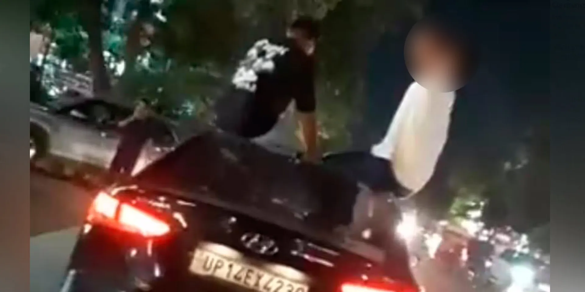 Two people were arrested for drinking while sitting on the top of the car