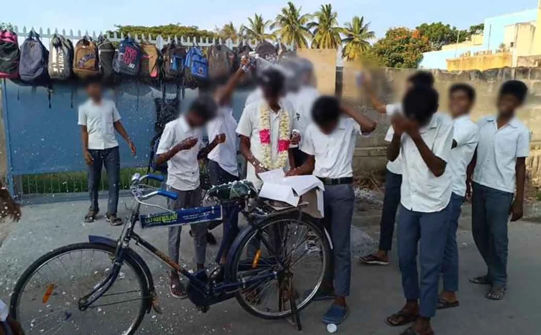 Birthday celebration of students by cutting a cake in middle of road 