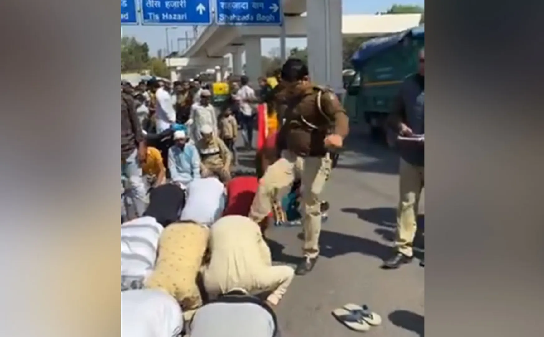 police kicking Muslims engaged in prayer in delhi